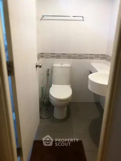 Compact modern bathroom with sleek fixtures and neutral tiles, perfect for urban living.