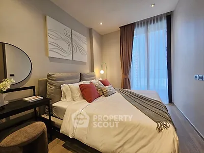 Luxurious bedroom with modern decor and large window offering natural light.