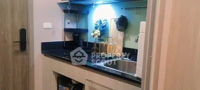 Modern compact kitchen with sleek cabinetry and stylish decor