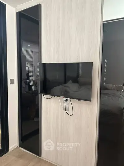 Modern bedroom with mounted TV and sleek design elements