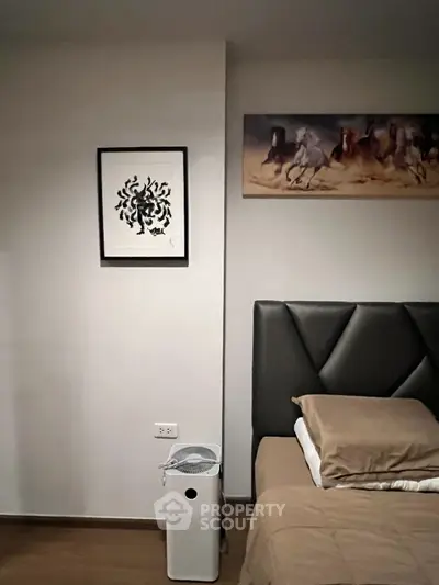 Modern bedroom with stylish headboard and contemporary artwork