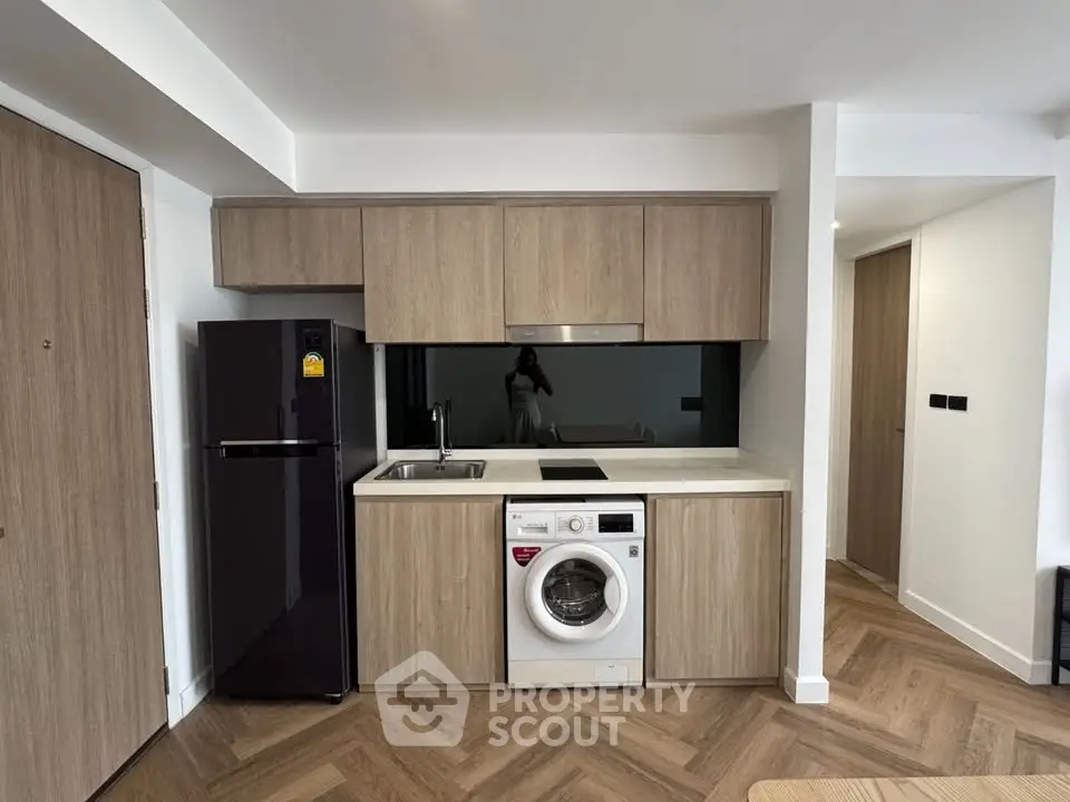 Modern kitchen with built-in washing machine and sleek appliances