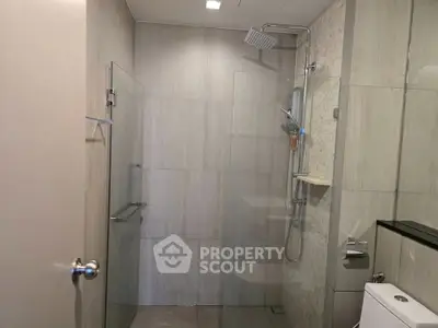 Modern bathroom with glass shower enclosure and sleek fixtures