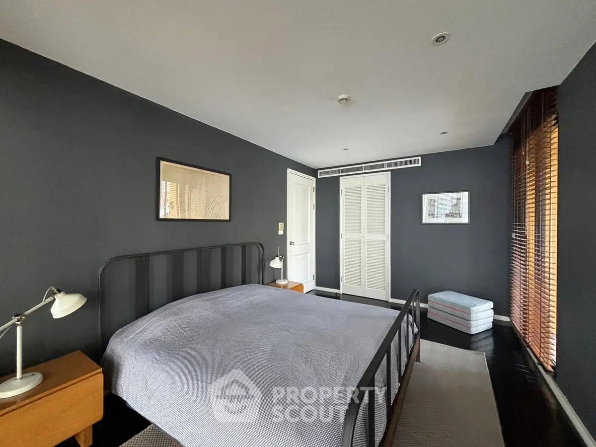 Stylish bedroom with dark walls and modern decor