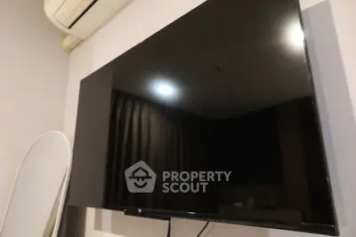 Modern living room with sleek TV and air conditioning unit, perfect for entertainment and comfort.
