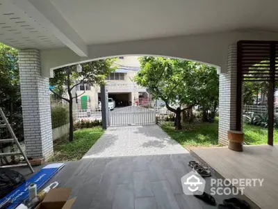 Charming covered patio with garden view and modern tile flooring