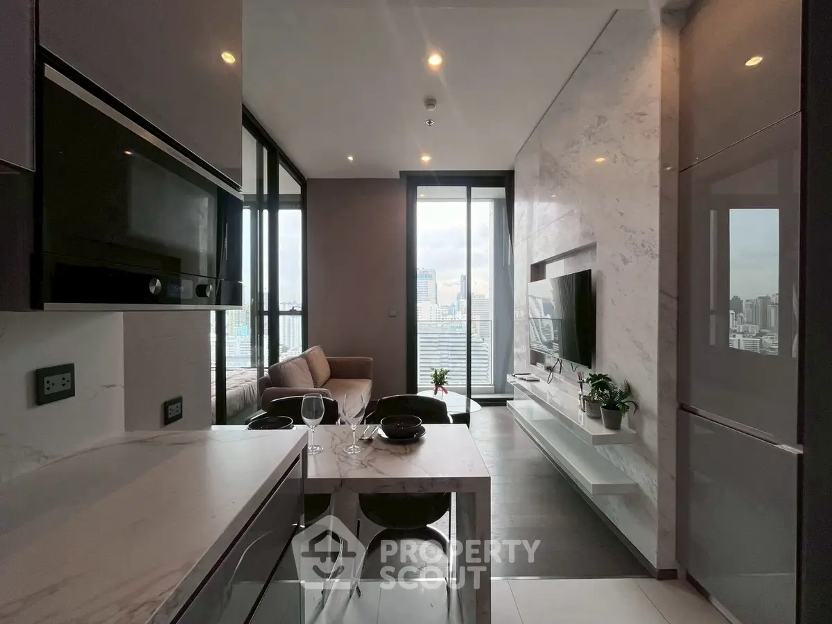 Modern open-plan kitchen and living area with city view, sleek design and natural light.