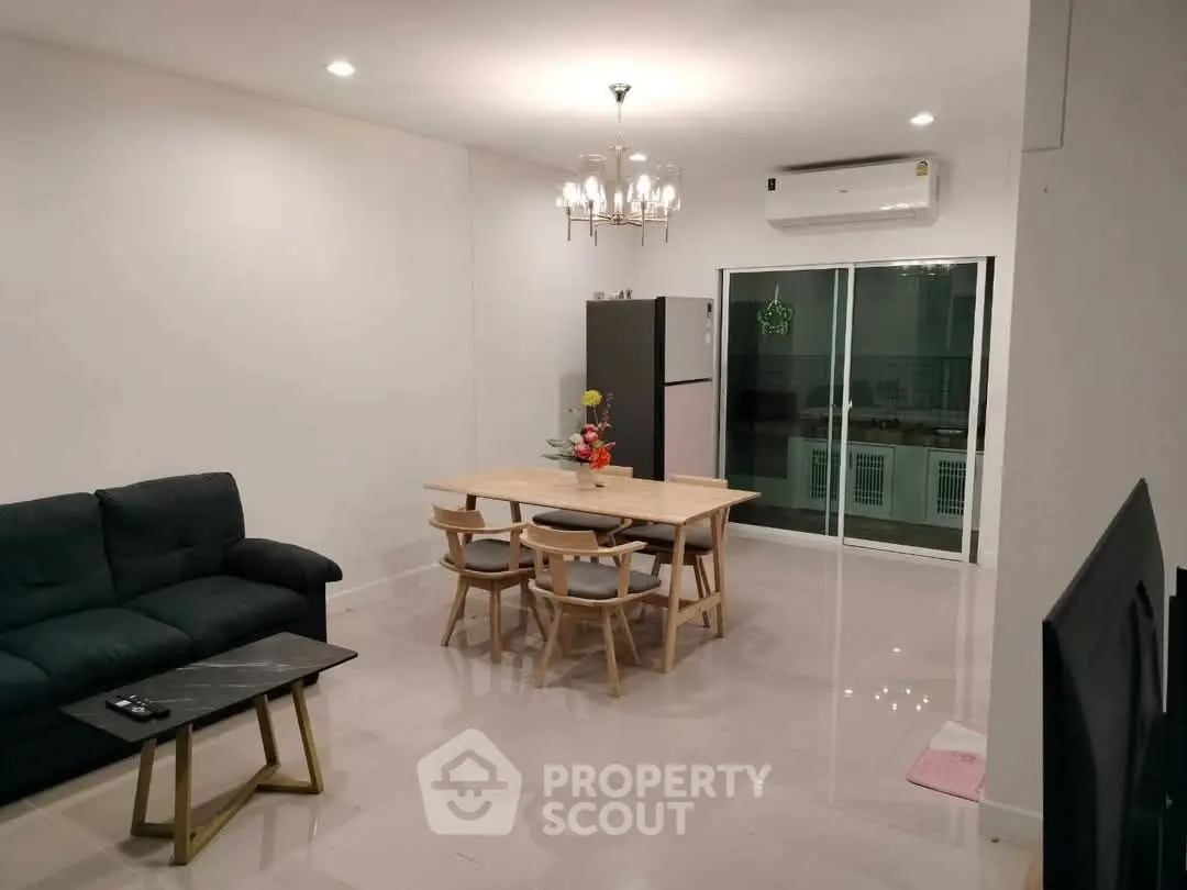 Elegant living room with modern chandelier and cozy seating area