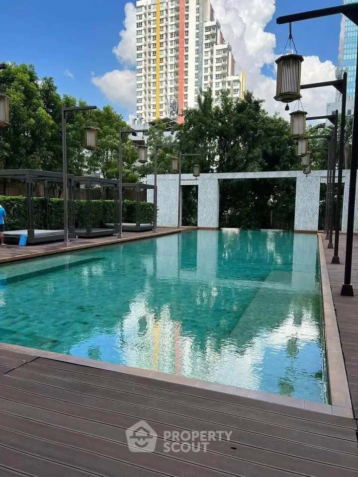Luxurious outdoor pool area with modern design and cityscape view, perfect for relaxation and leisure.