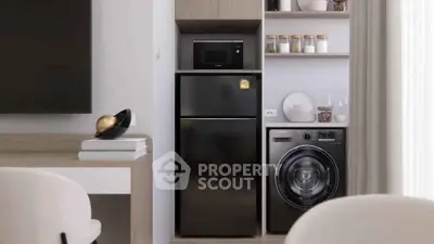 Modern kitchen with sleek appliances including fridge, microwave, and washing machine in stylish cabinetry.
