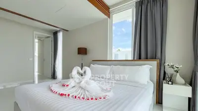 Luxurious bedroom with elegant decor and swan towel art on bed