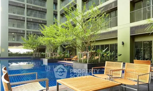 Luxurious apartment complex with serene poolside and lush greenery