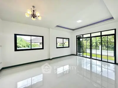 Spacious living room with large windows and garden view in modern home