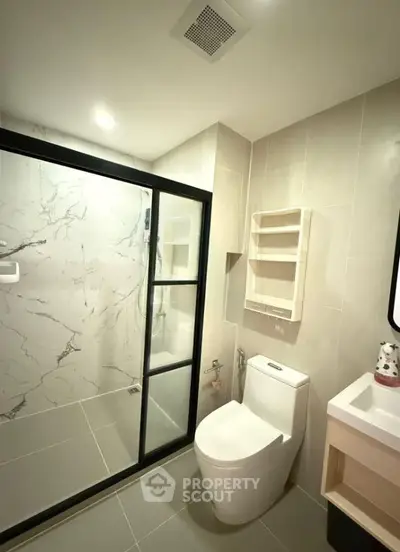 Modern bathroom with elegant marble shower and sleek fixtures