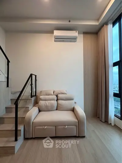 Modern living room with staircase and large window offering city view