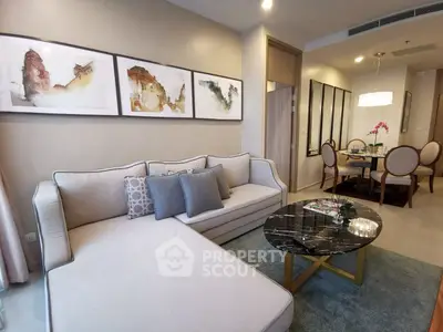 Elegant living room with modern decor and dining area in open layout apartment.