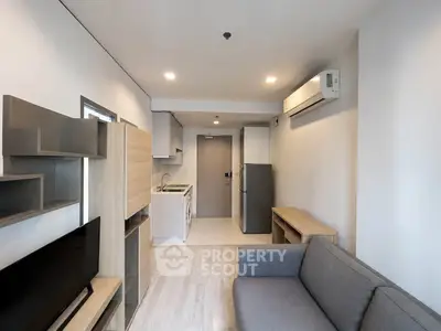 Modern apartment living room with sleek furniture and open kitchen layout