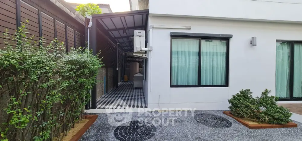 Modern home exterior with sleek design and lush greenery