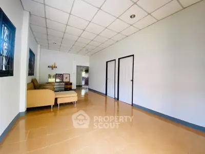 Spacious living room with modern decor and ample natural light