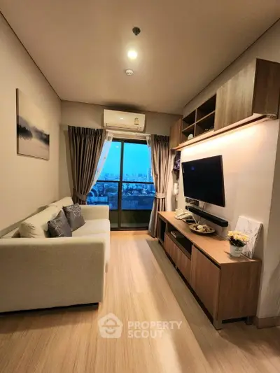 Modern living room with city view, cozy sofa, and sleek entertainment unit.