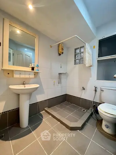 Spacious bathroom with modern fixtures and open shower design