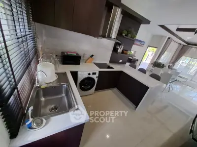 Modern kitchen with sleek cabinetry and integrated appliances in open layout
