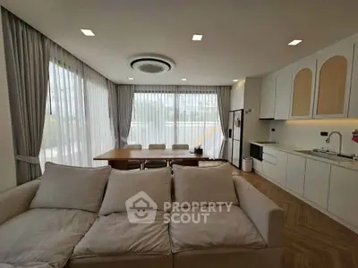 Spacious modern living room with open kitchen and large windows