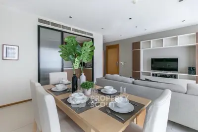 Modern living room with dining area, stylish furniture, and open layout in a contemporary apartment.