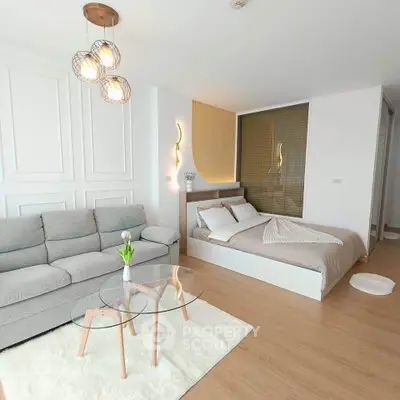 Modern studio apartment with cozy bed and stylish living area