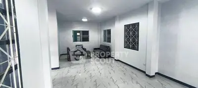 Spacious living room with modern furniture and tiled flooring