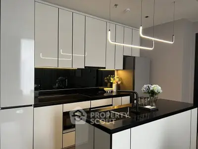 Modern kitchen with sleek cabinetry and stylish lighting in luxury apartment