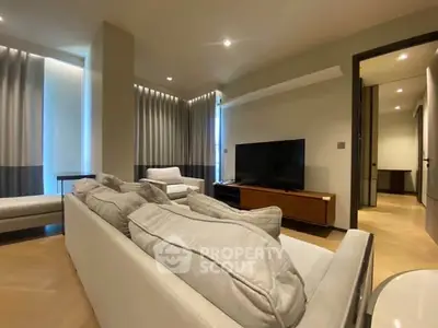Spacious modern living room with elegant decor and large TV setup