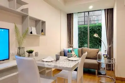 Modern living room with dining area, large window, and stylish decor in a cozy apartment.