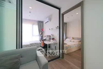 Modern apartment interior with cozy study and bedroom, featuring stylish furniture and natural light.