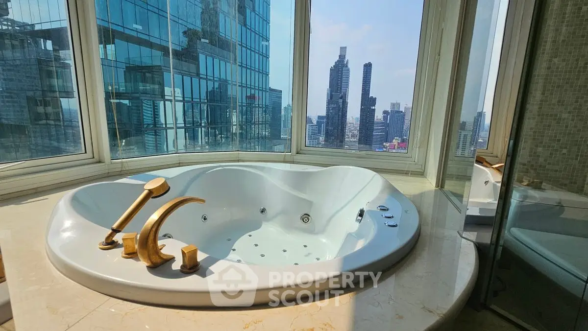 Luxurious bathroom with jacuzzi and stunning city view in high-rise apartment.