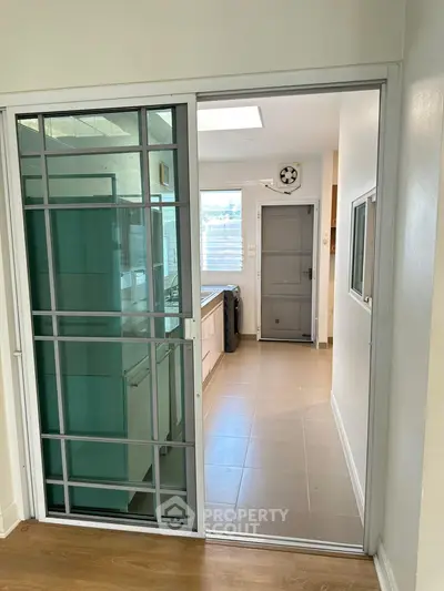 Modern kitchen with sliding glass door and sleek appliances