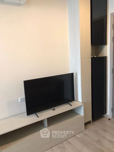 Modern living room with sleek TV setup and stylish storage solutions.