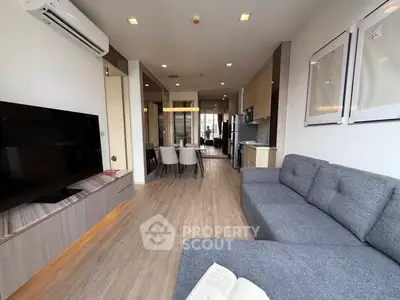 Modern living room with open layout, stylish furniture, and natural light.