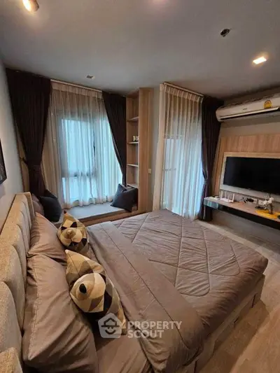 Luxurious bedroom with modern decor, large windows, and cozy ambiance in a stylish apartment.