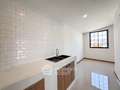 Modern kitchen with sleek white subway tiles and elegant wooden cabinetry