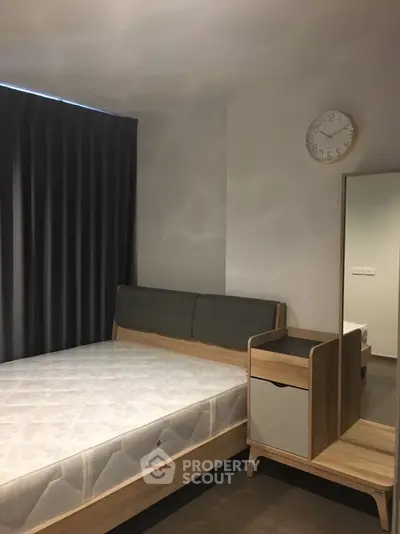 Modern bedroom with minimalist design featuring a comfortable bed and stylish furniture.