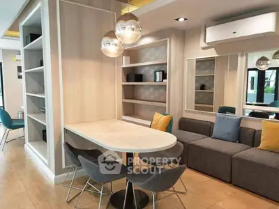 Modern living room with stylish furniture, built-in shelves, and contemporary lighting.
