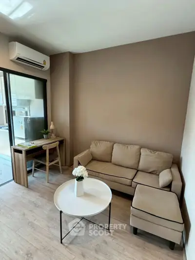 Cozy living room with modern furniture and natural light, perfect for relaxation and productivity.