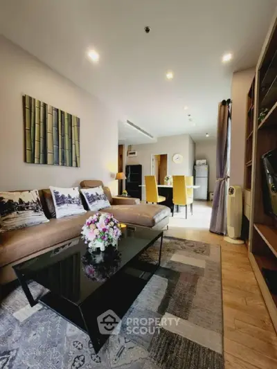 Modern living room with stylish decor and open layout, featuring a cozy seating area and elegant dining space.