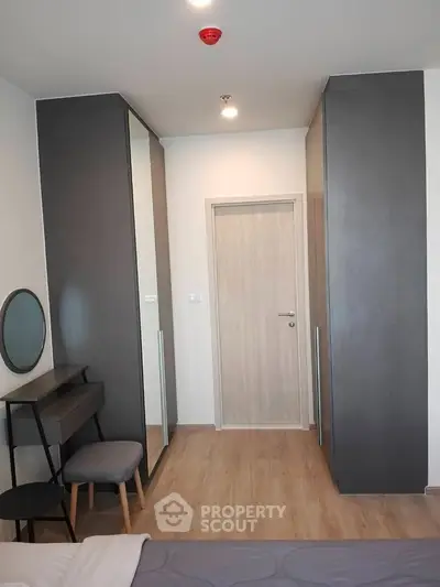 Modern bedroom with sleek wardrobes and minimalist decor