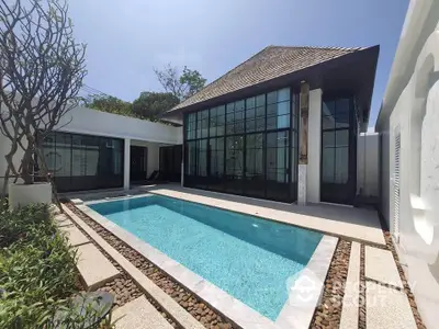 Luxurious villa with private pool and modern architecture in a serene setting.