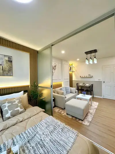 Modern open-plan living room and bedroom with stylish decor and cozy ambiance.