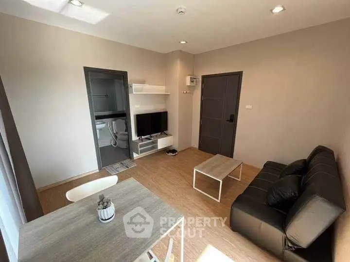 Modern living room with sleek furniture and natural light, perfect for urban living.