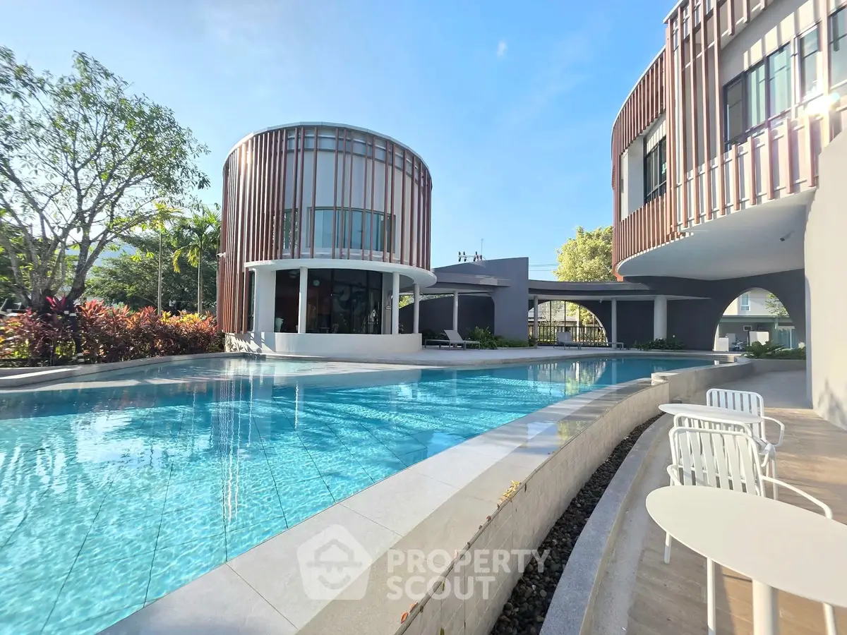 Luxurious modern building with stunning pool and outdoor seating area