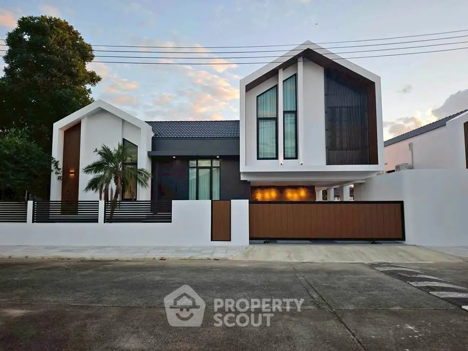 Modern architectural home with sleek design and large windows in a serene neighborhood.